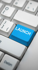 Blue launch button on a computer keyboard, symbolizing action and innovation