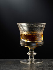 Brandy snifter on a black stone table.