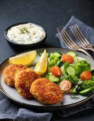 Generated image  Norwegian fish cakes (fiskekaker) served with a side of remoulade and fresh vegetables
