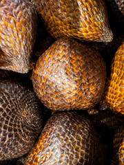  Close-up of fresh salak fruit, also known as snake fruit, with textured reddish-brown scaly skin.