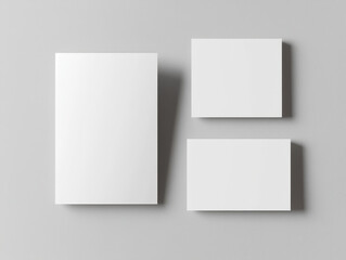 Blank white leaflets arranged on gray background, showcasing minimalist design ideal for branding or promotional materials. Perfect for creative projects and presentations