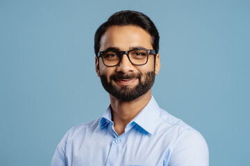 Handsome, successful Indian man, businessman wearing stylish eyeglasses, looking at camera