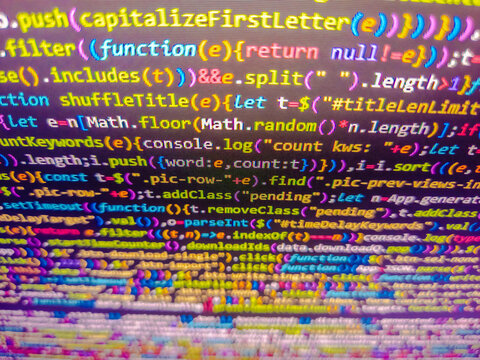 Developer screen with colored website programming code. The code is seen from top to bottom and its part of an library. Close up. Black color. Mosaic pattern. Background of program code.