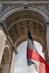 French flag under Arc de Triomphe. France, Paris, Etoile