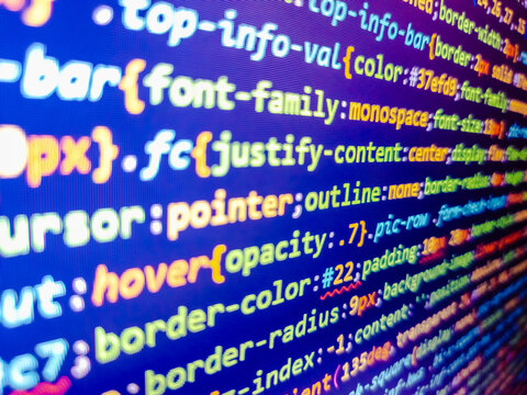 Software development by programmer. Real programmer monitor and screen. Stock market graph and ticker with blue screen for stock exchange analysis. Developer display with source code. Blue php.
