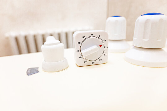 Timer and faucet handles on the bathtub in close-up. Temperature controller for spa treatments.