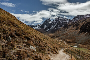 Hiking Trail Winding Through a Mountain Valley with a rock glacier in the background, Engadin, Switzerland