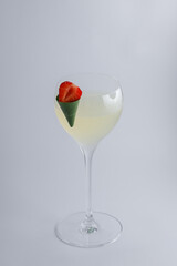 A beautiful martini glass elegantly featuring a fresh strawberry in it