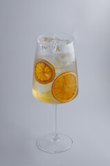 A wine glass filled with orange slices and ice, perfect for refreshment