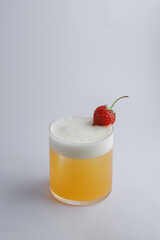 A refreshing drink that features a delightful strawberry on top