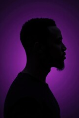 Silhouette of a Black Man Against a Rich Purple Background