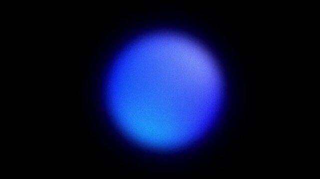 Abstract blurred grainy blue gradient glowing orb shape looped on black background