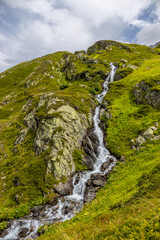 Alps scenic landscape on Tour du Montblanc. Rocky and snow summit peaks of the Alps on the trekking route TMB around Mont Blanc in Chamonix and Courmayeur. Alpine scene with mountains and lakes 