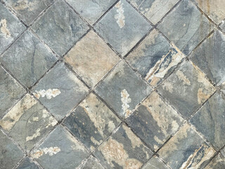 Natural stone marble tiles wall texture in mix of blue, grey, cyan color with random abstract veins. Diamond shape and arrangement marbled outdoor wall tiles seamless background.