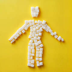 person made of sugar cubes, yellow solid background, diabetes concept, health issues 