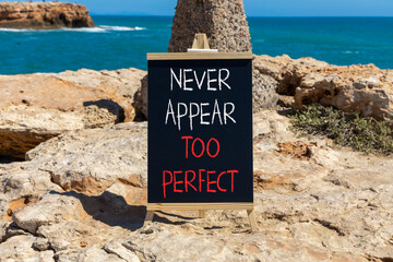 Never appear too perfect symbol. Concept words Never appear too perfect on beautiful black blackboard. Beautiful stone and blue sea background. Business never appear too perfect concept. Copy space.