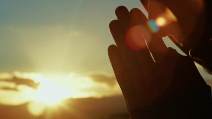 christian man prays with hands clasped