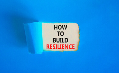 How to build resilience symbol. Concept words How to build resilience on beautiful white paper. Beautiful blue table blue background. Business and how to build resilience concept. Copy space.