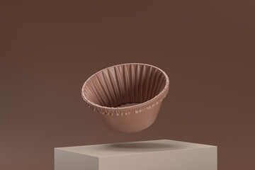A brown paper cupcake is floating in the air