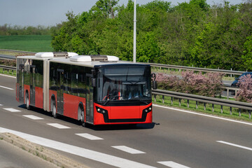 Fototapeta premium Red city bus on the highway