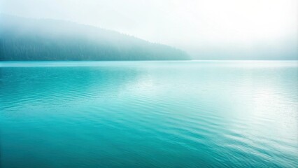 A serene landscape with a misty forest line silhouetted against a tranquil blue lake.