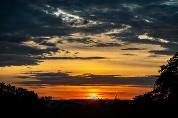 Dramatic sunrise with intense natural orange lights and idyllic dramatic scenery