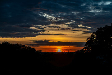 Dramatic sunrise with intense natural orange lights and idyllic dramatic scenery