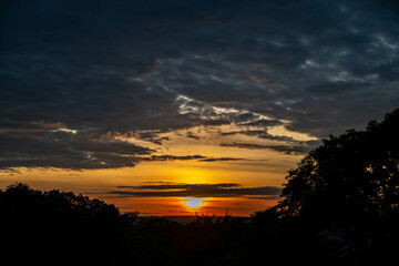 Dramatic sunrise with intense natural orange lights and idyllic dramatic scenery