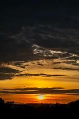 Dramatic sunrise with intense natural orange lights and idyllic dramatic scenery