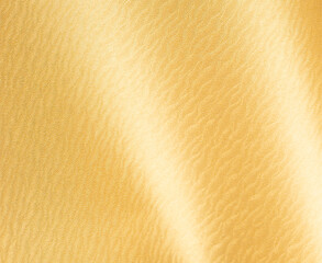 Gold glossy paper background. Shiny and smooth surface with a shimmering texture, perfect for elegant designs, celebrations, and decorative art. Luxurious and modern element with a
