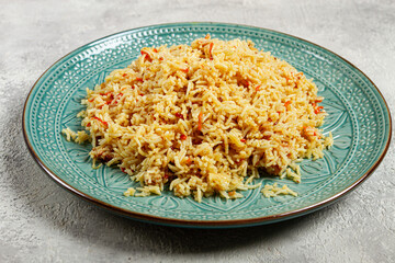 basmati rice with saffron, on a decorative blue plate, light background, homemade, no people,