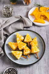 Christmas trees made of cheese and nachos on a plate on a table vertical view