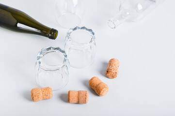 Alcoholism concept, empty glasses and bottles on grey background