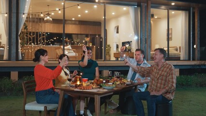 Happy family holding glowed sparkler in holiday celebration party at night. Lovely member enjoy playing spark toy together. Outdoor activity to cross generation gap strengthen family bond. Divergence.