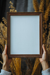 The girl holds a frame with a white background, for backgrounds. for advertising. for business.