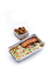 a white background disposable plastic and foil tableware airplane food snack Chinese steamed rice with vegetables with fish cutlet with stewed vegetables healthy eating