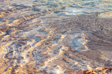 Surface of deserted place loks like as bottom of the ocean with difference ravines.This strange place is located on bottom of Masada mountain.