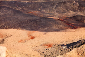 Fragment Makhtesh Ramon  surface, that looks like an some cosmic landscape of Mars planet with craters, hills and desert colored in red and dark brown shades