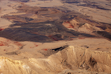 Fragment Makhtesh Ramon  surface, that looks like an some cosmic landscape of Mars planet with craters, hills and desert colored in red and dark brown shades