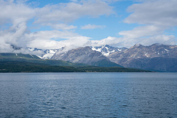 Snowy mountains, fjord and blue sky in Norwegian landscape in Olderdalen, Norway