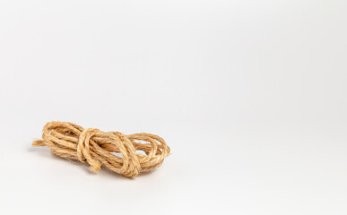 A skein of woven rope  on a white background.
