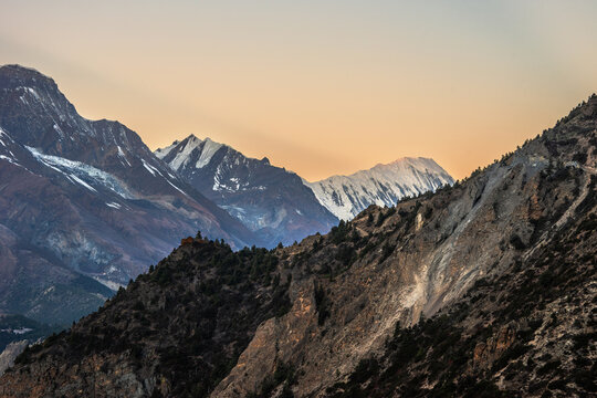 Pangi Lama Durbar against Tilicho peak at sunrise. View from Ghyaru village.