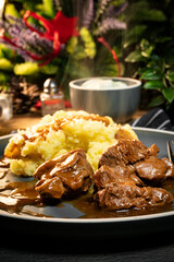 Stewed turkey meat served with sauce and mashed potatoes.