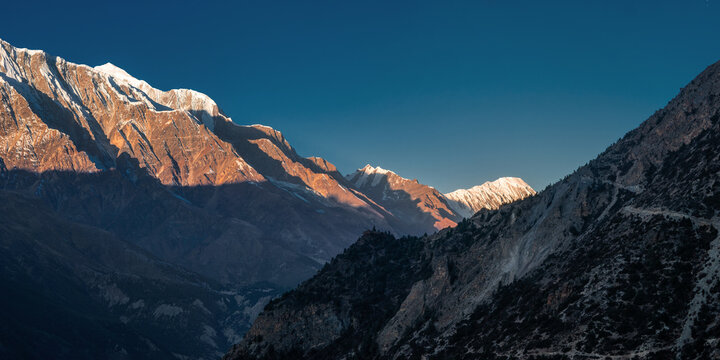 Panoramic view of the Pangi Lama Durbar against Mt. Gangapurna and Tilicho peak after sunrise. Early morning in Ghyaru village near Manang. Annapurna circuit trek, Himalaya, Nepal.