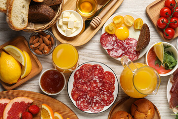 Different tasty food served for brunch on white wooden table, flat lay