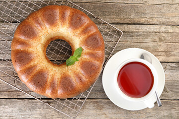 Freshly baked sponge cake and tea on wooden table, top view