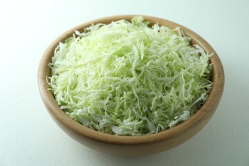 Fresh shredded cabbage on light table, closeup