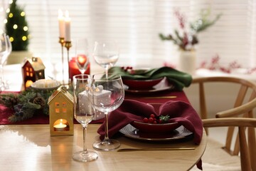 Christmas table setting with stylish dishware and festive decor indoors