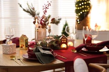 Christmas table setting with stylish dishware and festive decor indoors