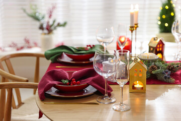 Christmas table setting with stylish dishware and festive decor indoors